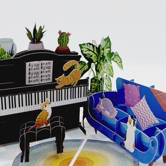 A pop-up card featuring a cats with a piano, showing all side of the pop up card