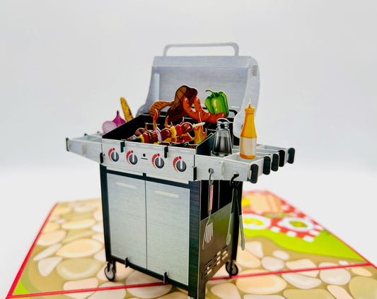 Brightly colored BBQ pop-up card featuring a grill, burgers, and hotdogs