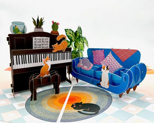 A 3D pop-up card featuring a cat playing a piano, perfect for a music lover's birthday
