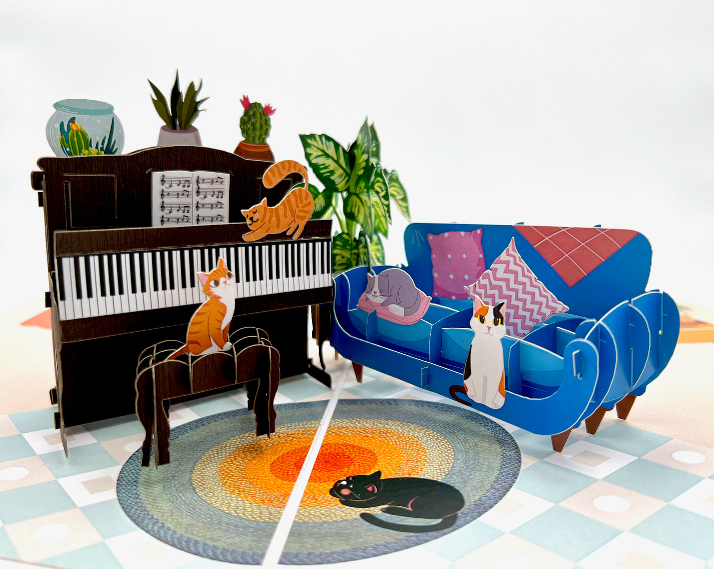 A 3D pop-up card featuring a cat playing a piano, perfect for a music lover's birthday