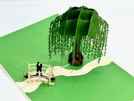 Beautifully detailed pop-up card of couple on a bridge under willow tree, great as a valentine's pop up card